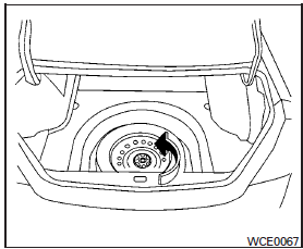 Turn the clamp to remove the spare tire. Remove